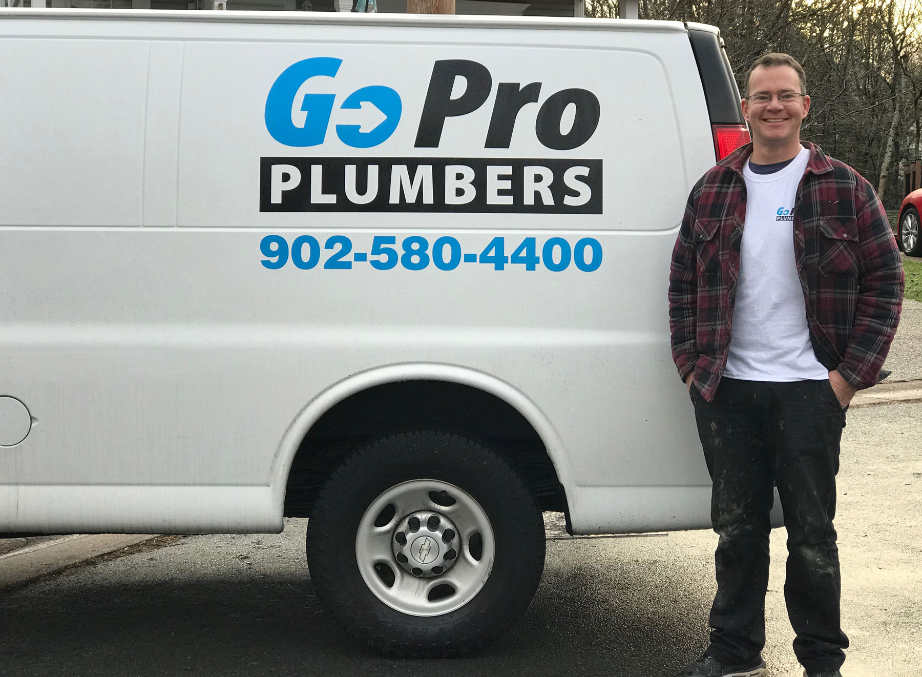 Matt Gore standing beside the GoPro Plumbers van